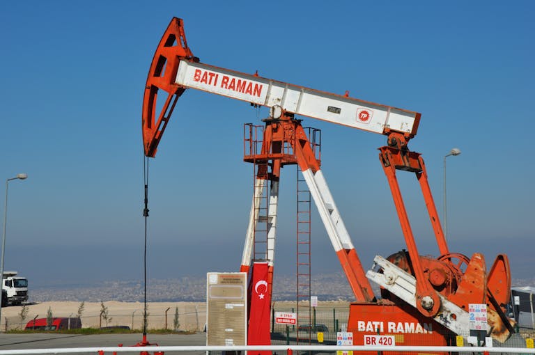 Bati Raman oil pump jack in Batman, Turkey. Industrial landscape with city view.
